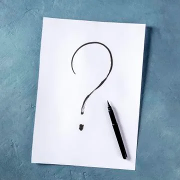 Question mark, written in ink on a piece of standard office paper, overhead Stock Photos