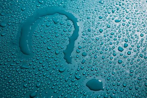 Question mark is written with water surrounded by drops of water. Close-up. A Stock Photos