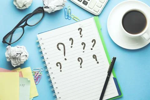 Question Mark written on a white notebook Stock Photos