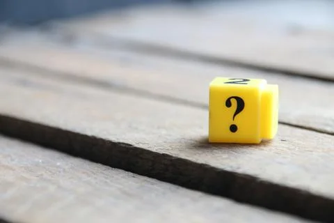 Question mark on a yellow cube. Place for text. Stock Photos