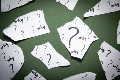 Question marks and Why? word on torn papers. Stock Photos