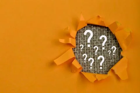 Question marks drawn on brown background with copy space Stock Photos