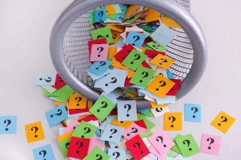 Question marks falling out of trash can Stock Photos