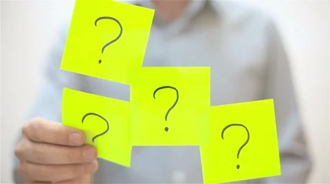 Question marks. A man sticks a note on transparent screen Stock Footage 68088734