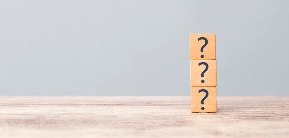 Question marks on the table written in a row on cubes. Frequently asked quest Stock Photos