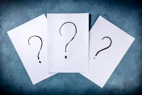 Question marks, written in ink on a piece of standard office paper, shot from Foto stock