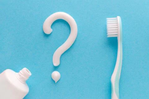 Question from toothpaste, teeth care concept, toothbrush on blue background Stock Photos