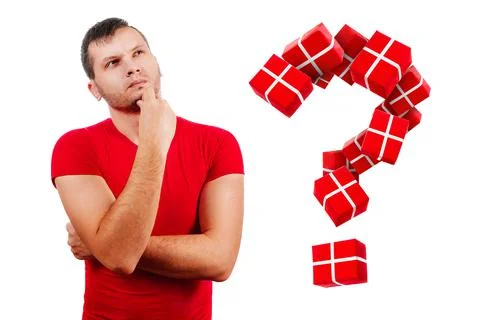 The question of what to present for the new year. A man in a red T-shirt on a Stock Photos