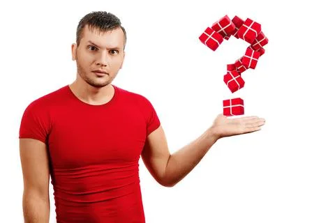 The question of what to present for the new year. A man in a red T-shirt on a Stock Photos