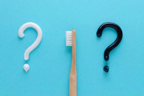 Question from white and black toothpaste, teeth care concept, wooden toothbrush Stock Photos