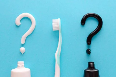 Question from white and black toothpaste, teeth care concept, toothbrush on blue Stock Photos
