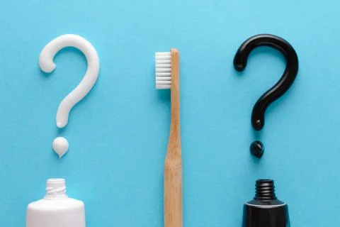 Question from white and black toothpaste, teeth care concept, wooden toothbrush Stock Photos