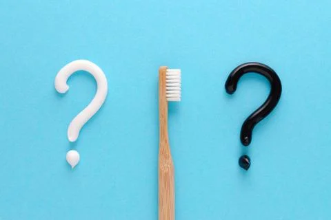 Question from white and black toothpaste, teeth care concept, wooden toothbrush Stock Photos
