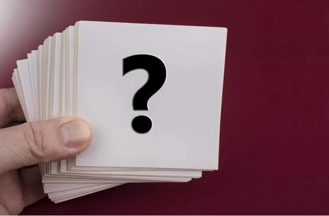 Questionmark sign on a white paper note on a red Stock Photos