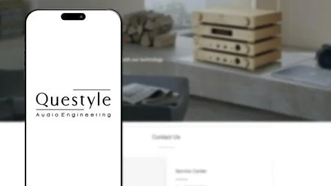 Questyle logo on smartphone screen Stock Photos