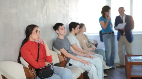 Queue of applicants in reception room, senior male manager talking to office Stock Footage 341534002