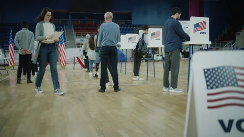 Queue of diverse American citizens come to vote in polling station Stock Footage 273856499