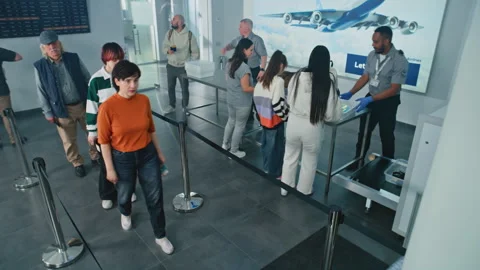 Queue of Diverse People Passing Biometric AI Face Scanning at Border Control in Stock Footage 305648581