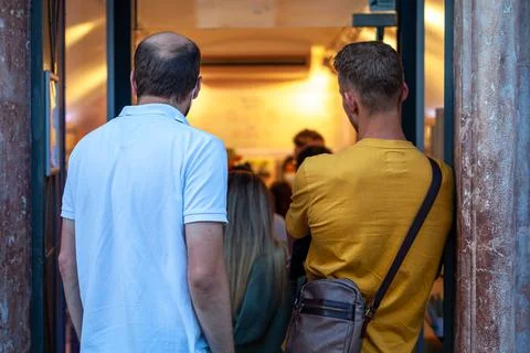Queue at the door to the store 스톡 사진