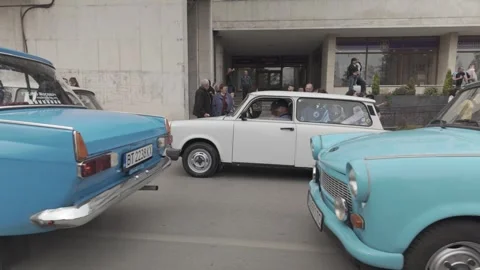 Queue of East German retro classic cars on city street SLOW DOLLY shot Stock Footage 305611481