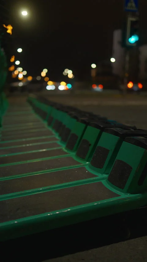 Queue of electric blue scooters arranged on dark city road at midnight Stock Footage 270388380