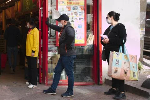 Queue in front of a market Stock Photos