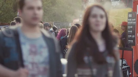 Queue line to burger fast food stand at crowded city park outdoor festival Stock Footage 78859482