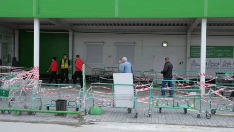 Queue many man face masks corona virus store. Line trolley wait queue covid-19. Stock Footage 130379580