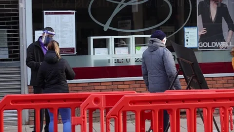 Queue with mask waiting to enter Natwest bank Stock Footage 148174882