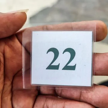 The queue number of the laminated paper in hand 스톡 사진