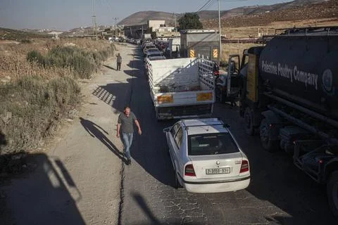  A queue of Palestinian vehicles seen waiting at the Beit Furik checkpoint... Stock Photos