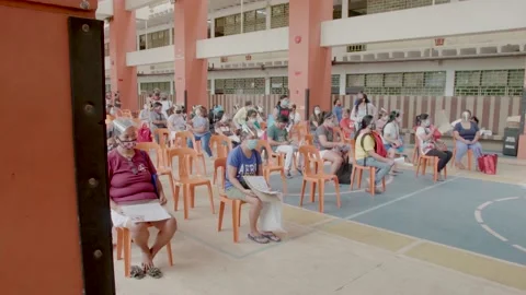Queue of parents wait for free android tablet for online classes Video stock 142575240