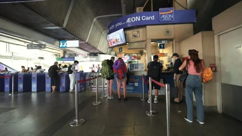 Queue of passengers buying tickets at the ticket office at BTS station, high Stock Footage 248130476