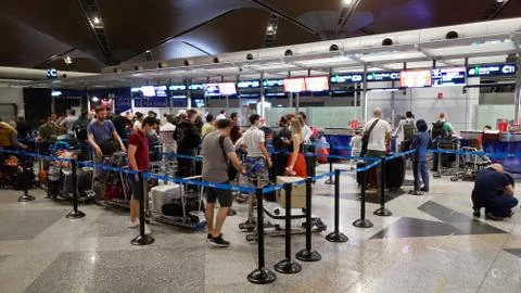 The queue of passengers at the check-in and ticket-granting counter in the ai Stock Photos