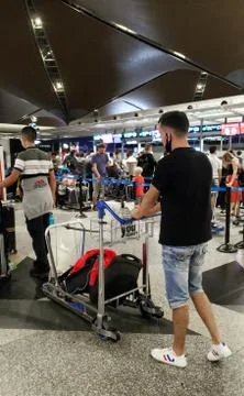 The queue of passengers at the check-in and ticket-granting counter in the ai Stock Photos