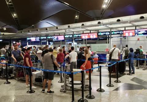 The queue of passengers at the check-in and ticket-granting counter in the ai Stock Photos