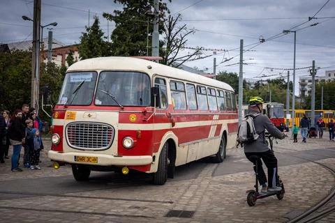 A queue of passengers getting into vintage bus at the bus station. Stock Photos