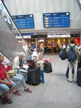 Queue of passengers standing for tickets at ticket office of railway station Stock Photos