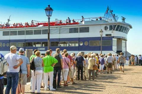 Queue of passengers waiting to board a ferry in Italy Stock Photos