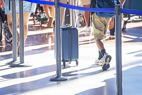 Queue of passengers waiting to check in for their flight; air travel Stock Photos