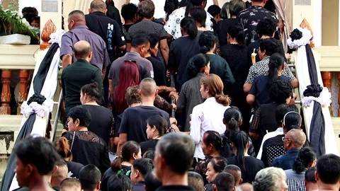 A Queue of people advancing up to the crematorium. Stock Footage 122755653