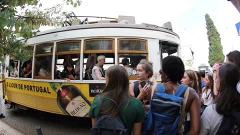 Queue of people to catch the famous yellow tram in Lisbon Stock Footage 113884963