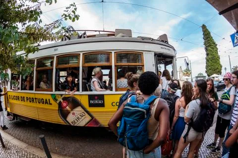 Queue of people to catch the famous yellow tram in Lisbon Stock Photos
