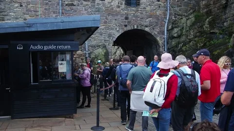 Queue of people at edinburgh castle returning audio guides Stock Footage 142854441