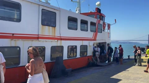 Queue of people embarking on boat at Cacilhas to Lisbon Stock Footage 220150827