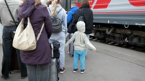 A queue of people with luggage waiting to board a long-distance train. Passenger Video stock 288949086