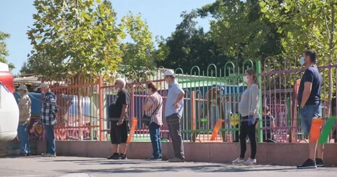Queue of people with masks, waiting to vote at local elections, advance slowly Stock Footage 139964970