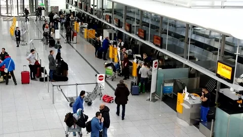 Queue of people at the Munich airport check-in counter Stock Footage 72249790