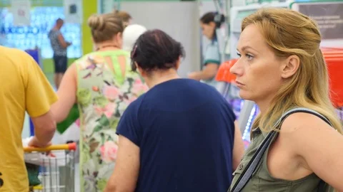 The queue of people standing at the checkout in the supermarket. 4k, slow motion Stock Footage 79951261