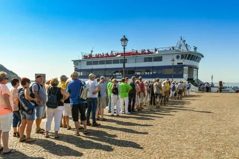 Queue of people waiting to board a ferry on Lake Garda 스톡 사진